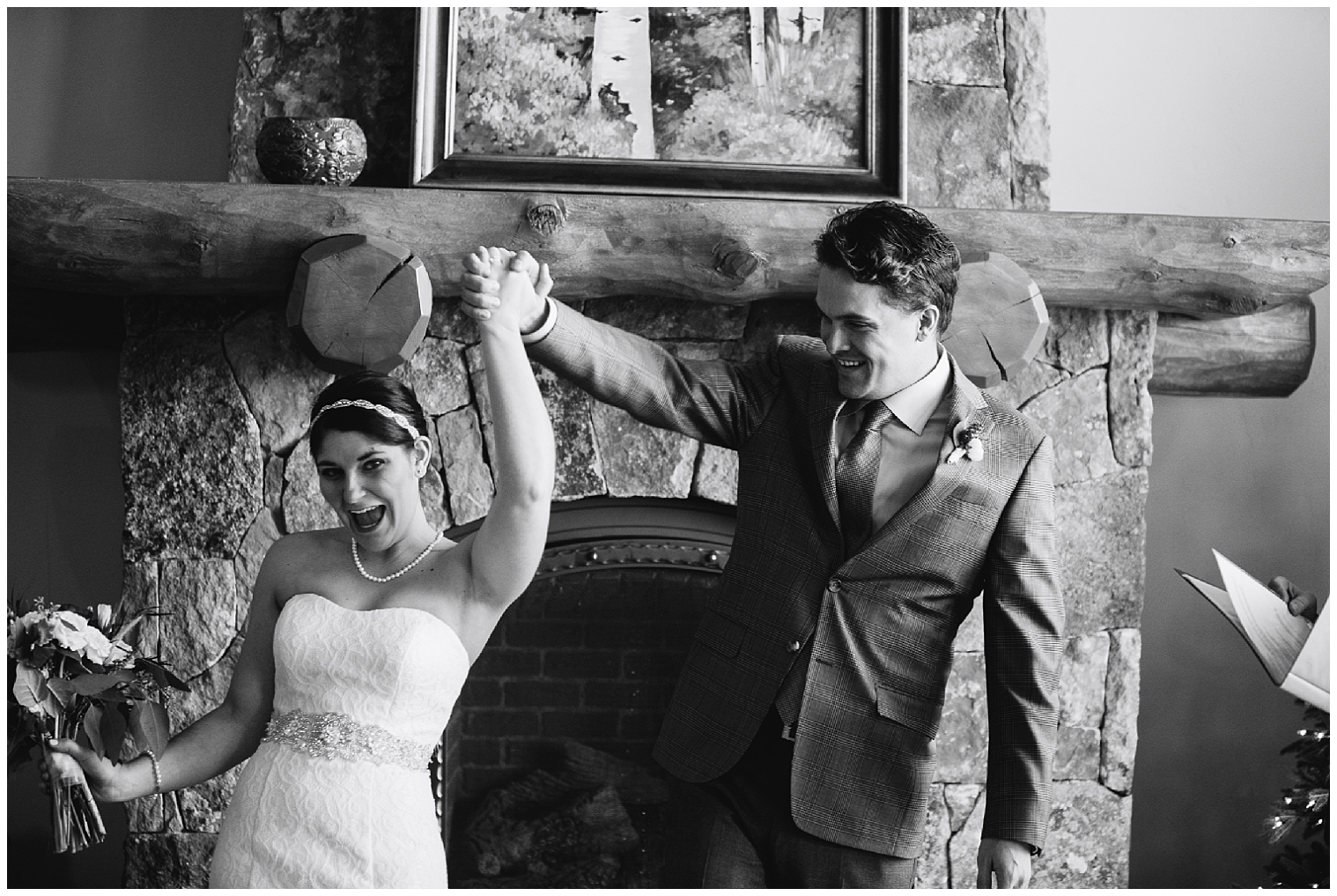 Bride and groom raise their hands triumphantly after their Breckenridge elopement ceremony.