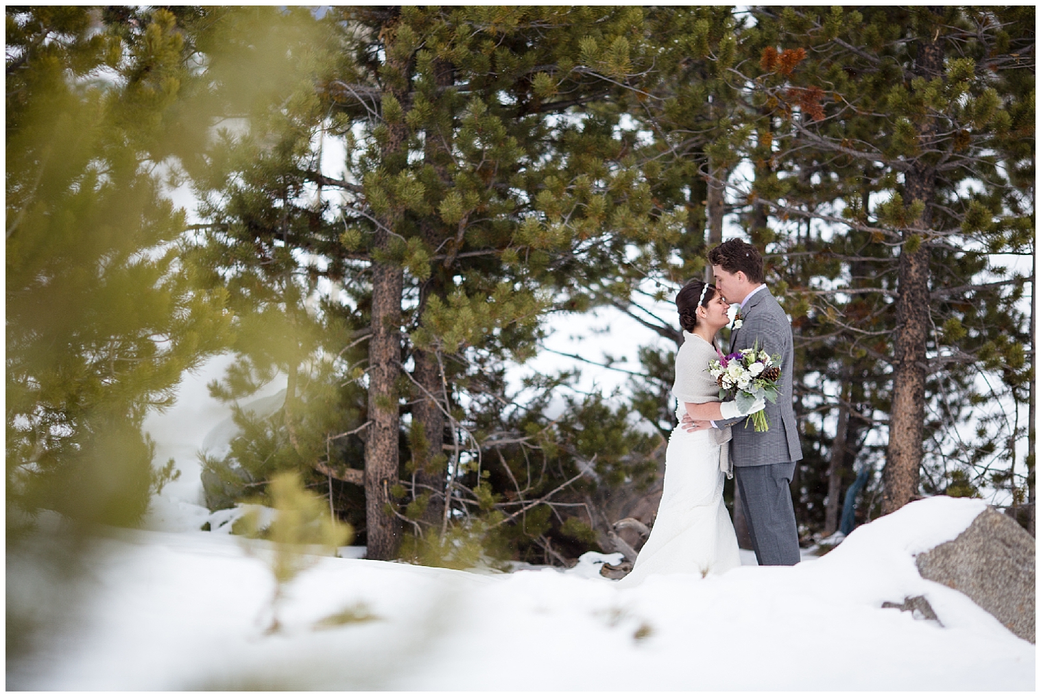 Bride and groom embrace in the snow at their Breckenridge elopement.