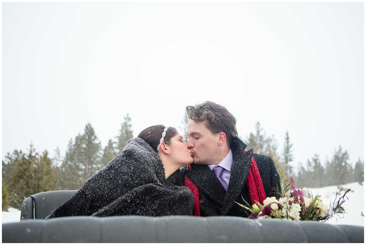 The bride and groom kiss in the carriage at their winter mountain elopement in Breckenridge Colorado.