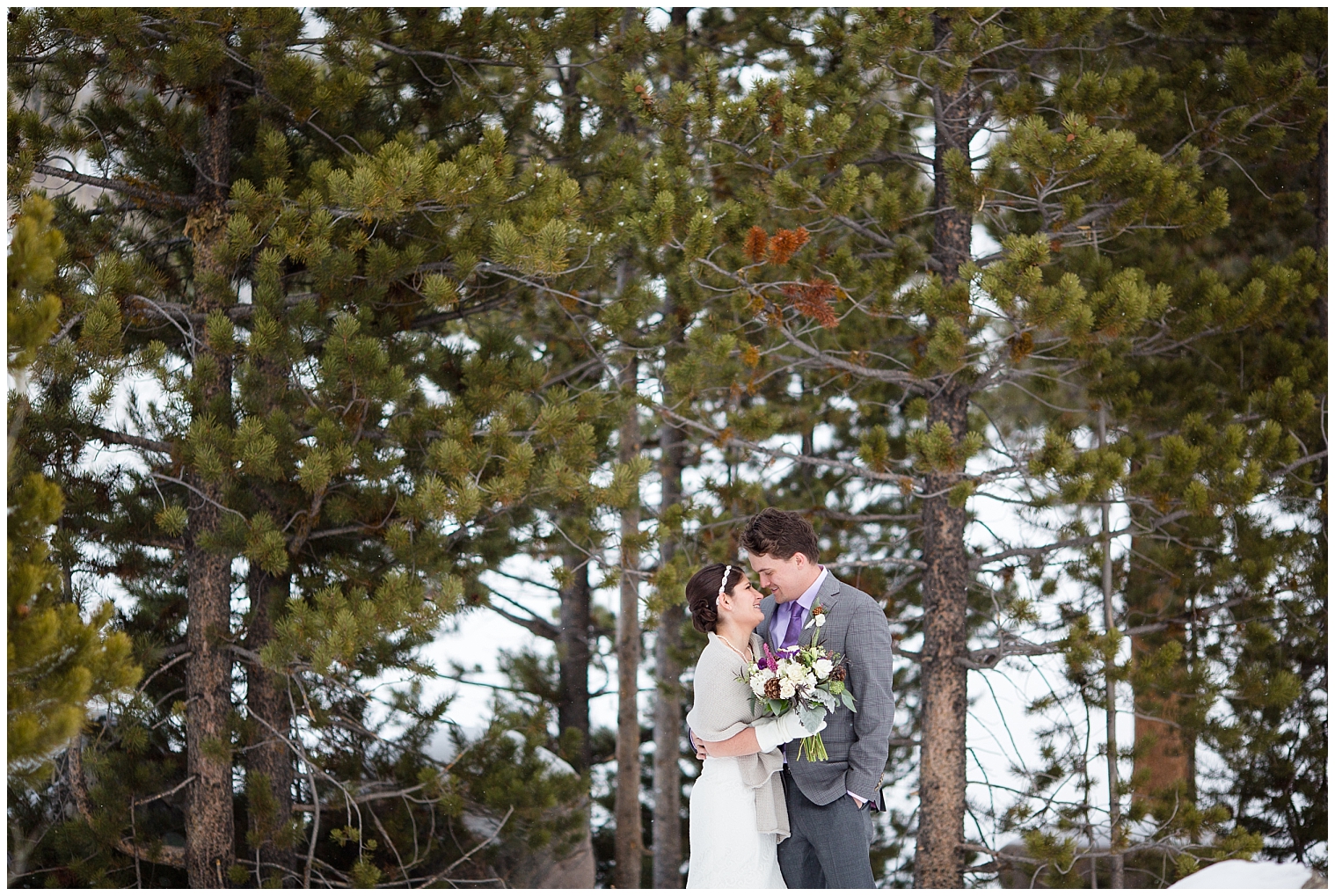 The wedding couple hold one another during portraits at their Breckenridge Colorado mountain elopement.