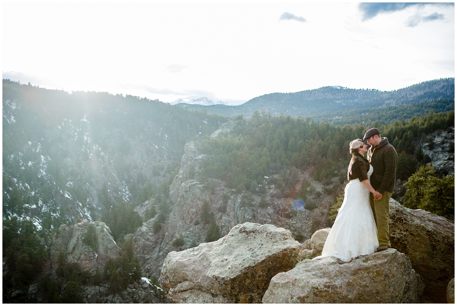 The wedding couple stand together in the mountains at their Boulder Colorado elopement.