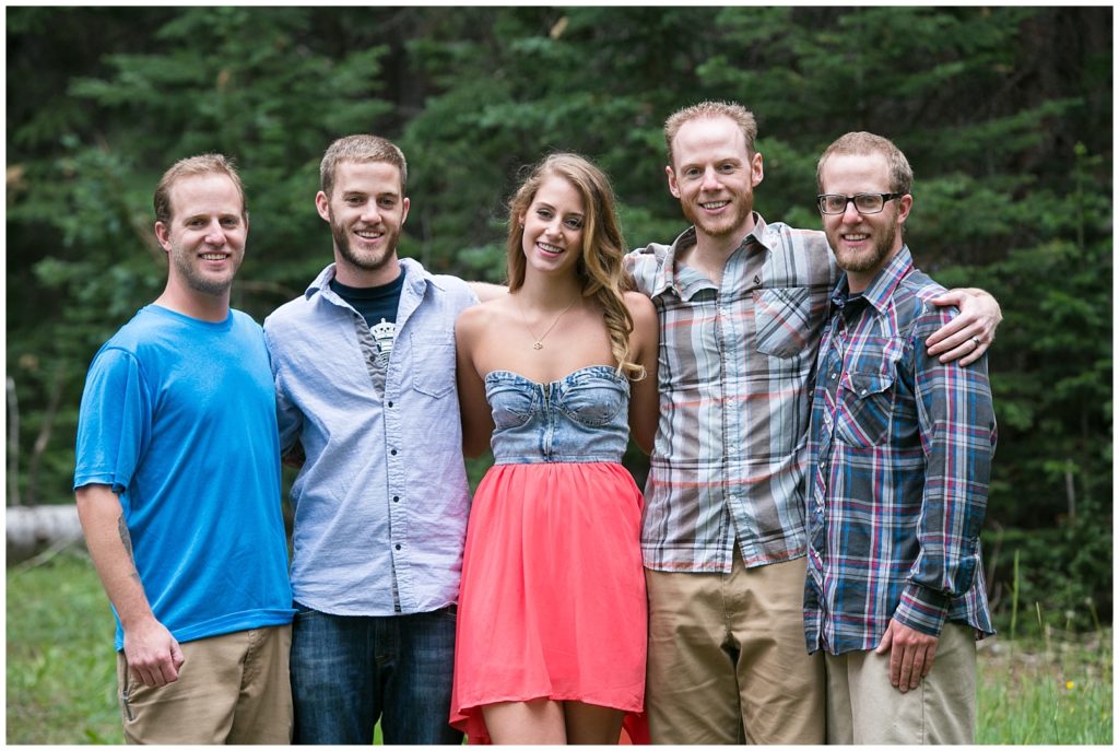 Siblings pose together for a photo by a Breckenridge extend family photographer.
