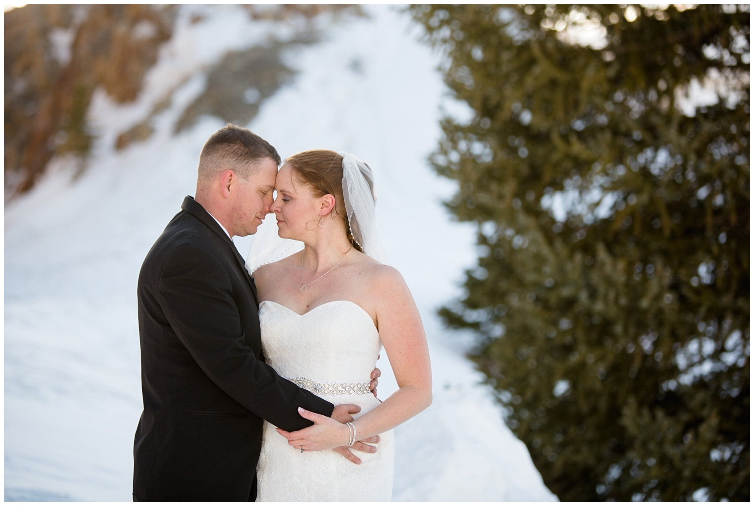 The bride and groom snuggle together during portraits at their Breckenridge Colorado mountain elopement.