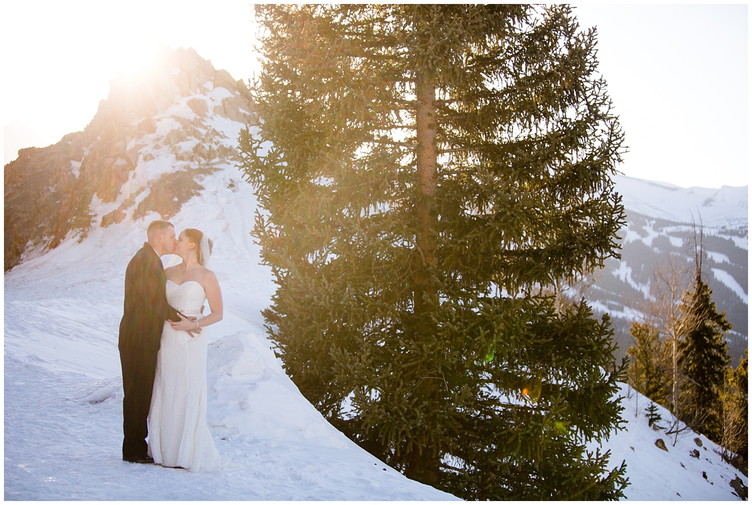 At their Breckenridge elopement, the bride and groom kiss in the mountains.