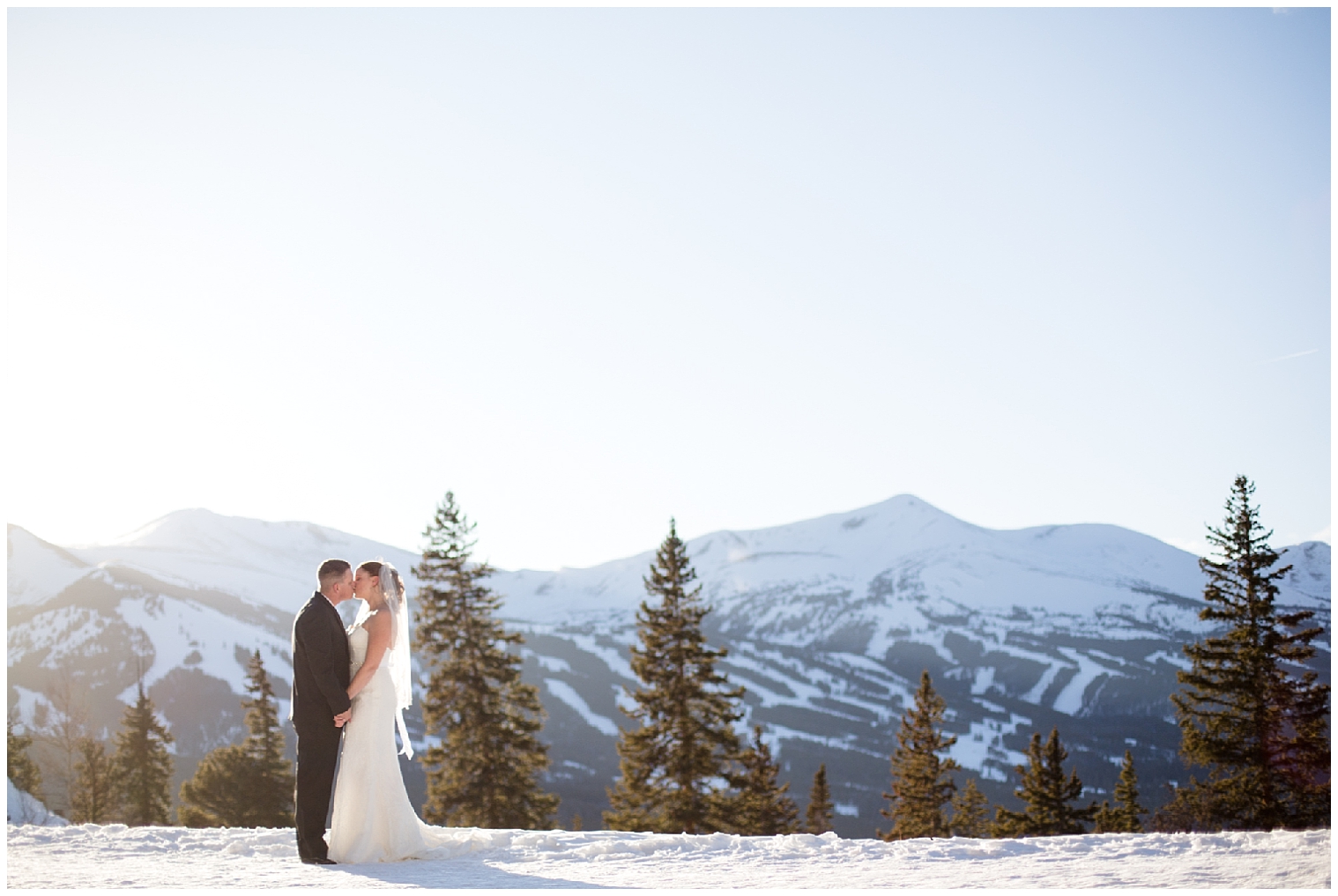 Boreas Pass Breckenridge elopement couple kiss atop a Colorado mountain.