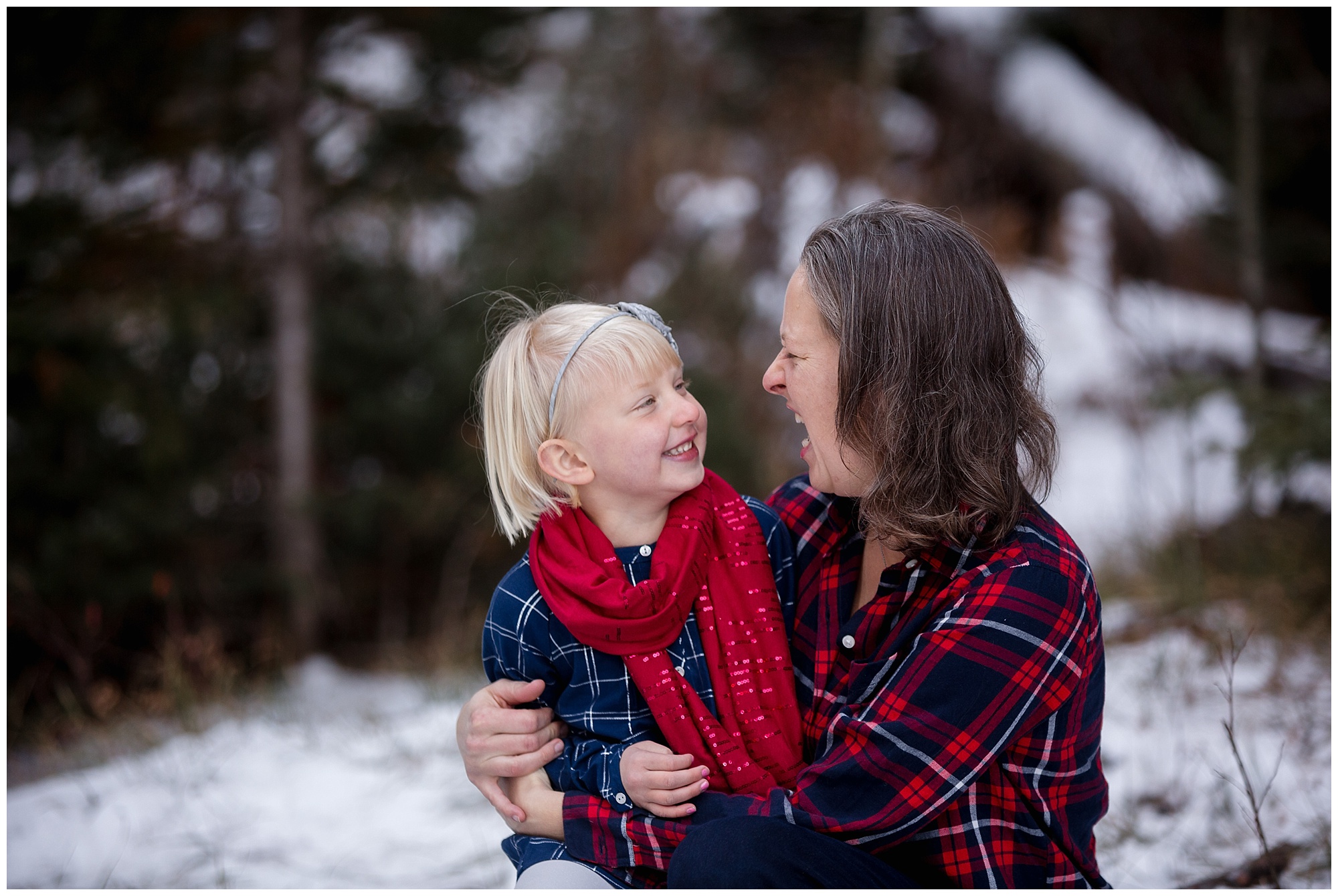 During a Colorado winter family photo session, a mother holds her daughter close.
