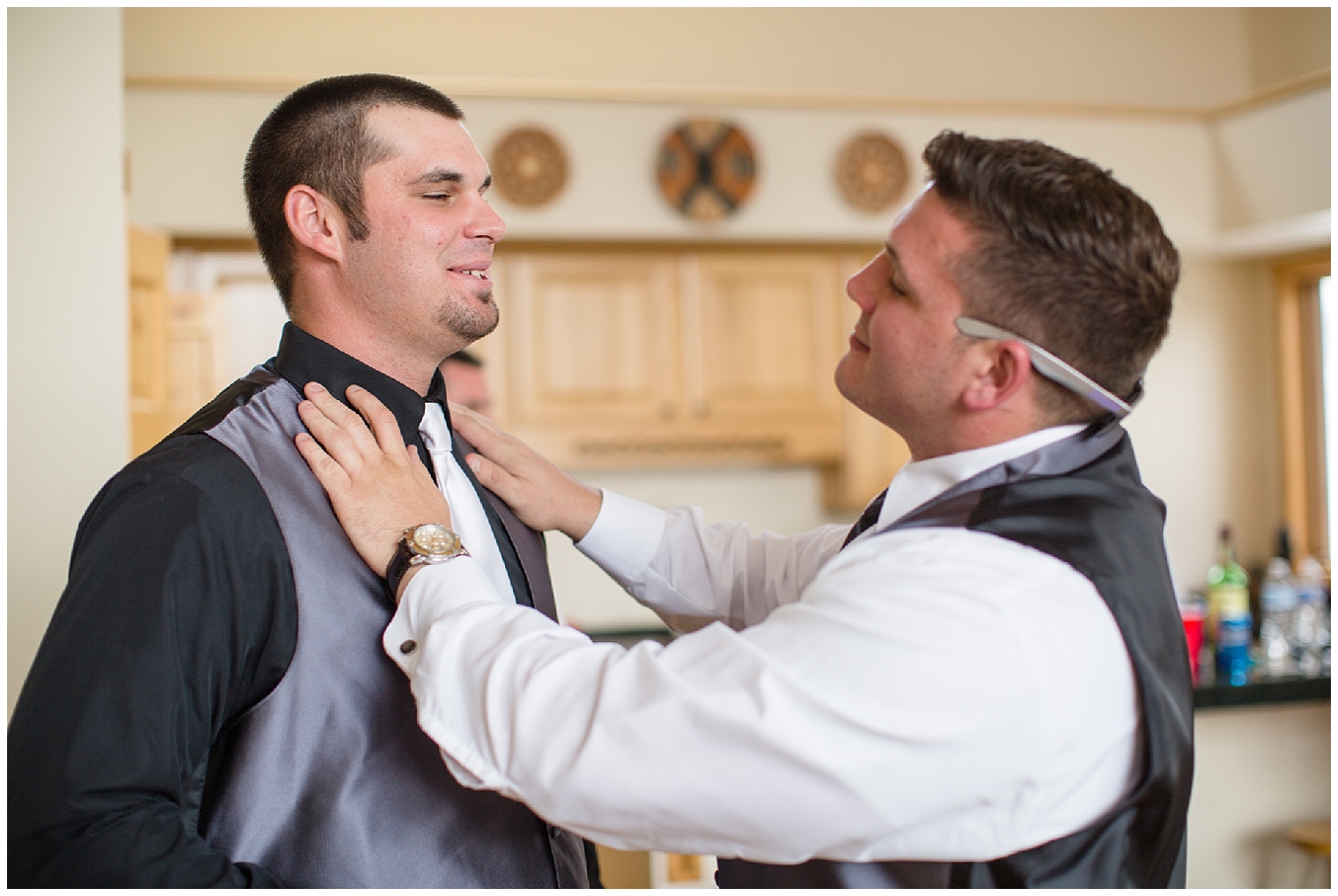 Groomsman adjusts the groom's tie prior to a Sevens wedding.