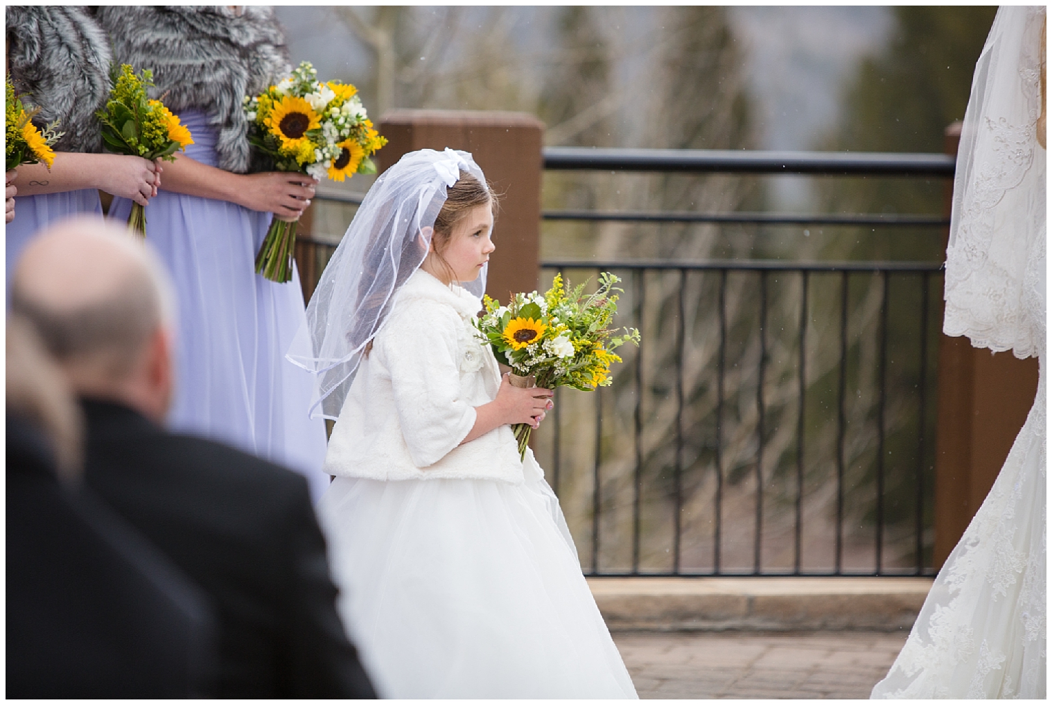 Flower girl stands during a wedding ceremony at Sevens in Breckenridge.