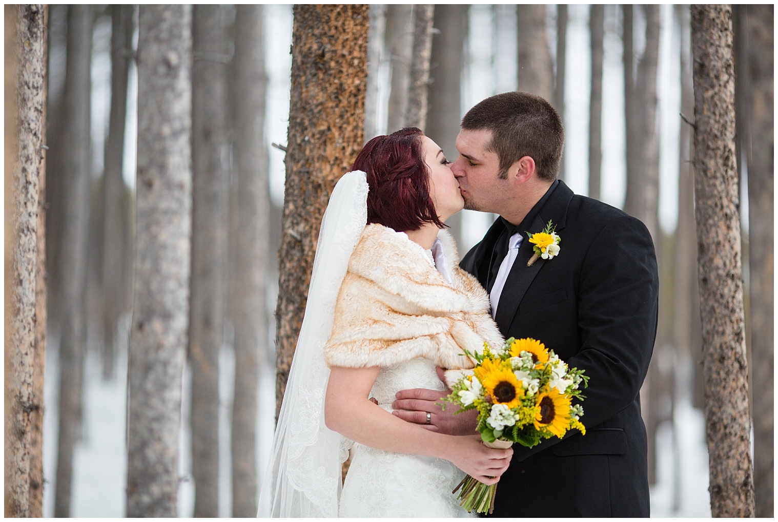 The wedding couple kiss at their Breckenridge Colorado wedding.