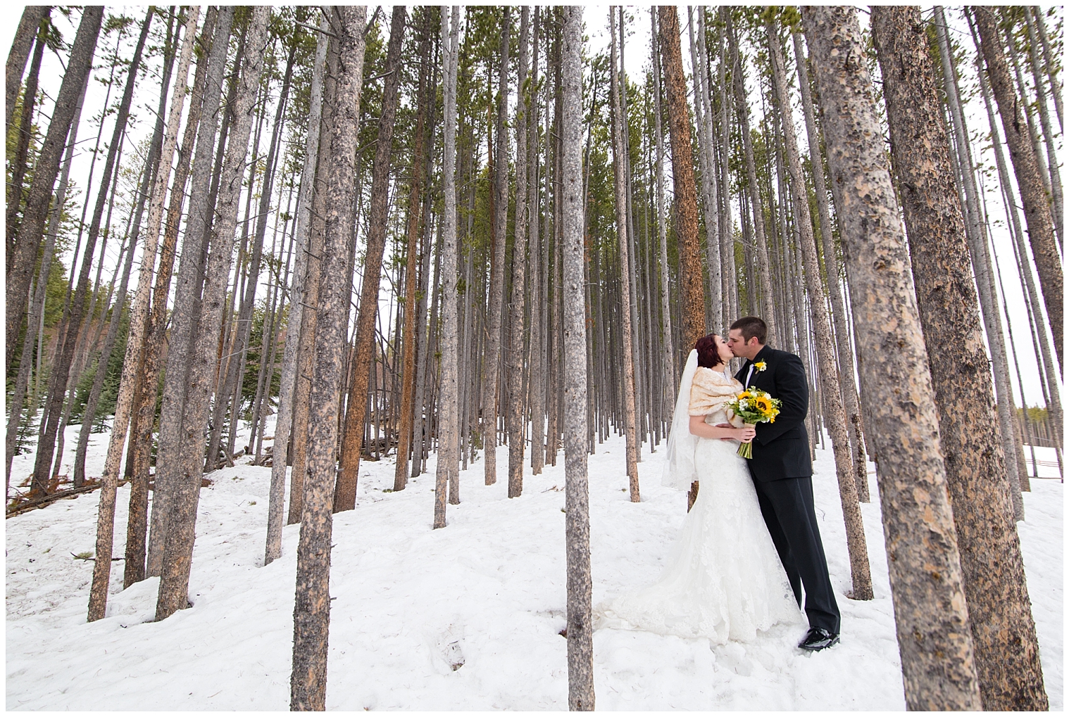 The bride and groom kiss at their winter wedding at Sevens in Breckenridge.