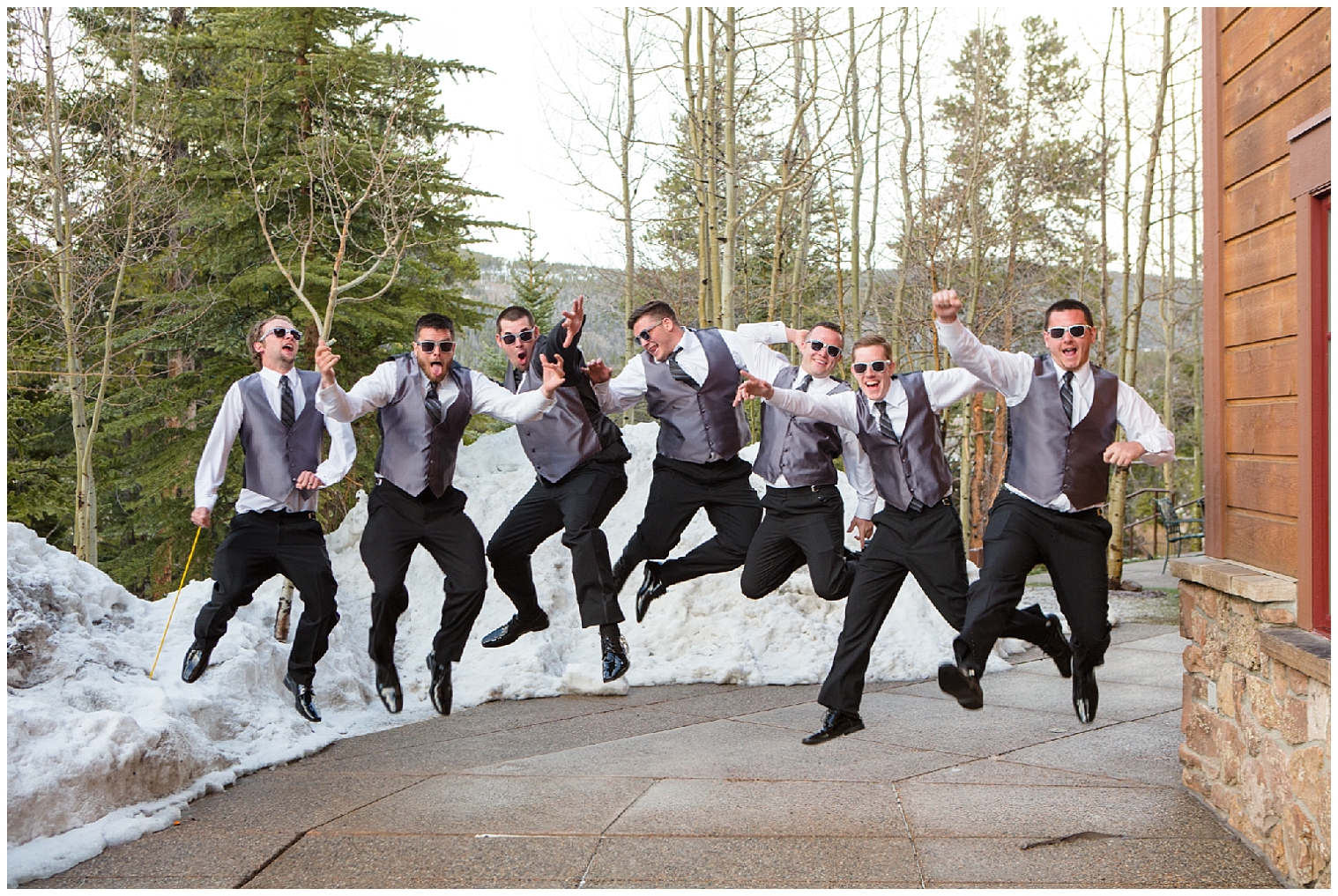 Portrait of groom and his groomsmen jumping a Breckenridge mountain wedding.