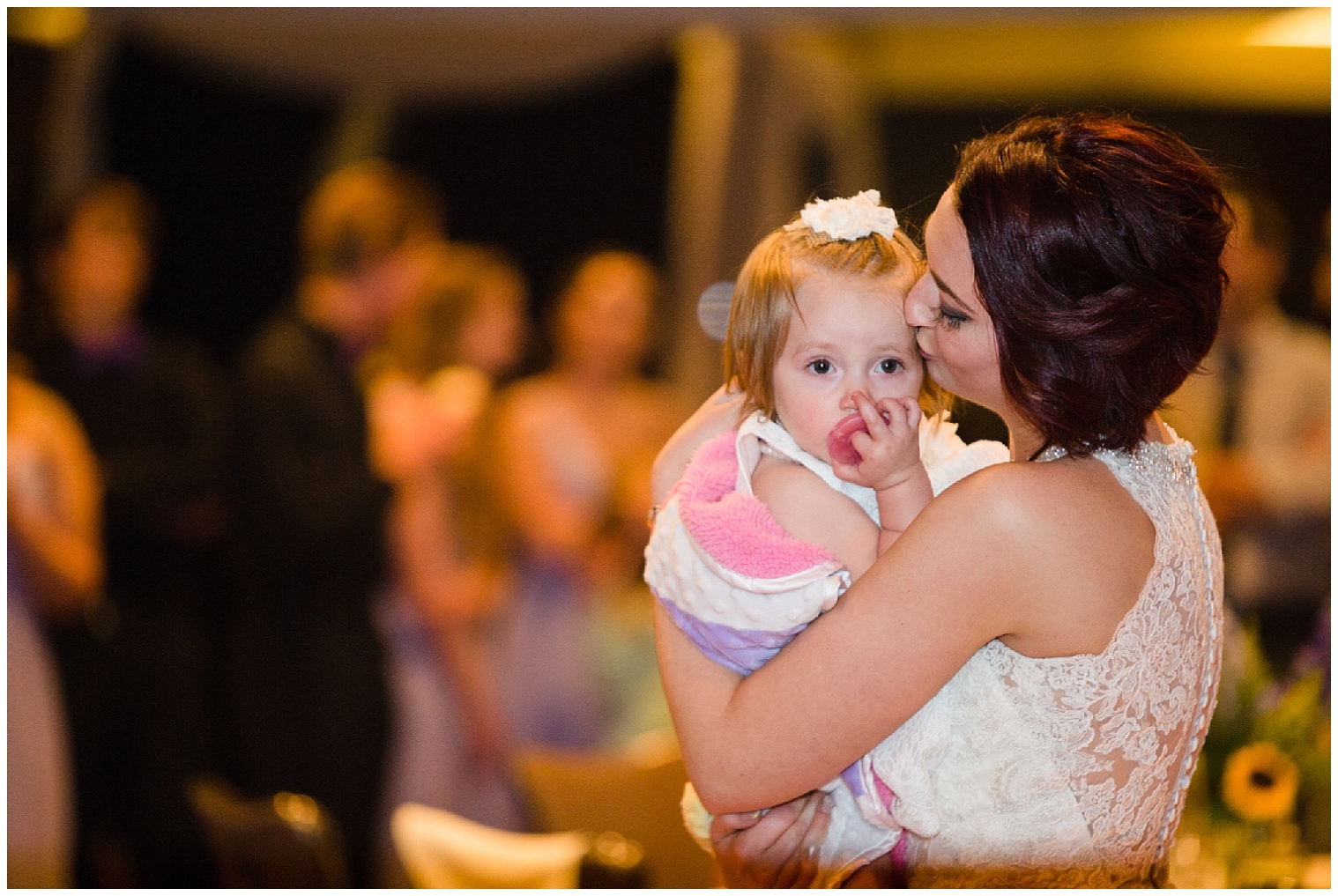 Bride holds her daughter during a special dance during her Sevens wedding in Breckenridge.