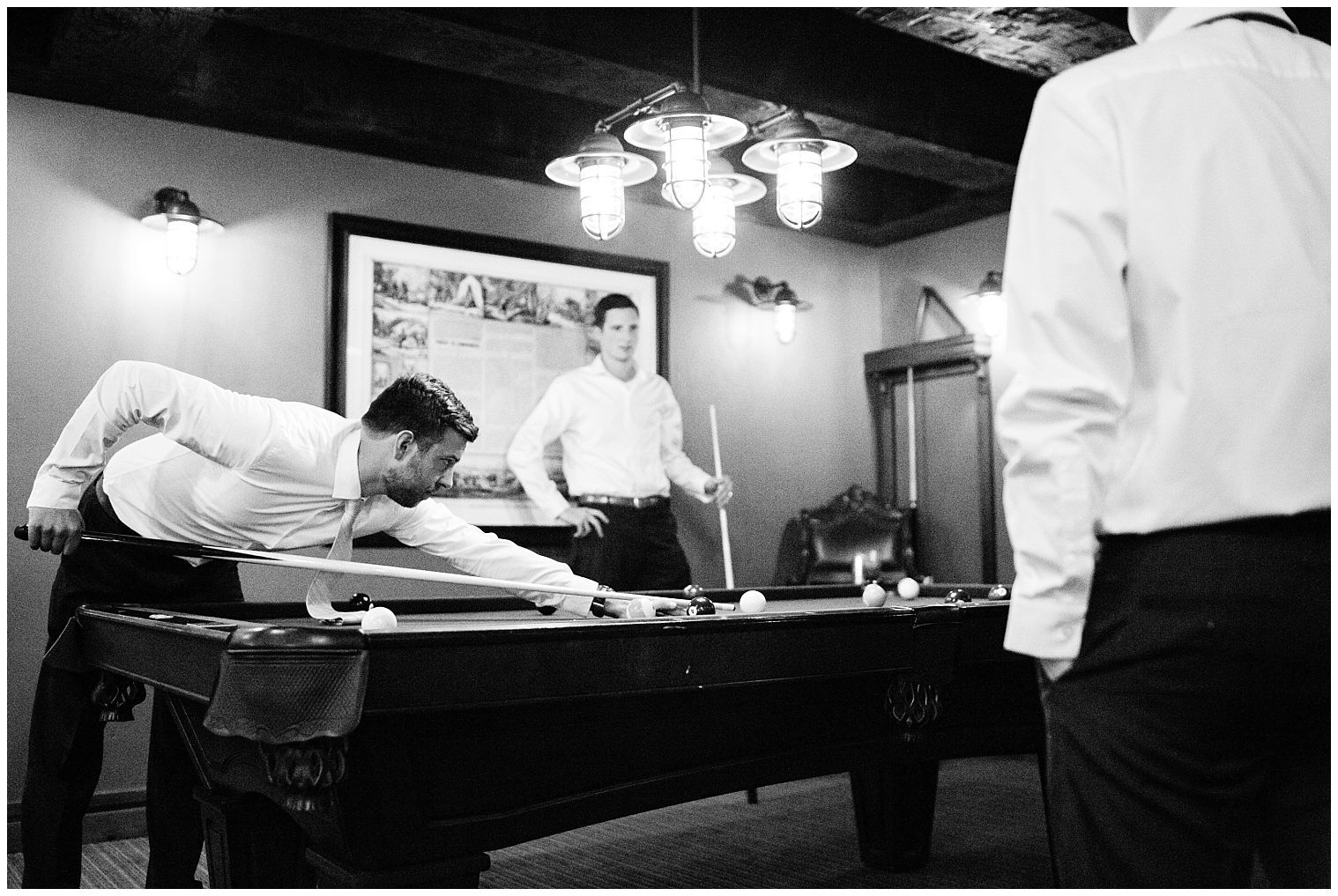 Before his Copper mountain wedding, the groom plays pool with his groomsmen.