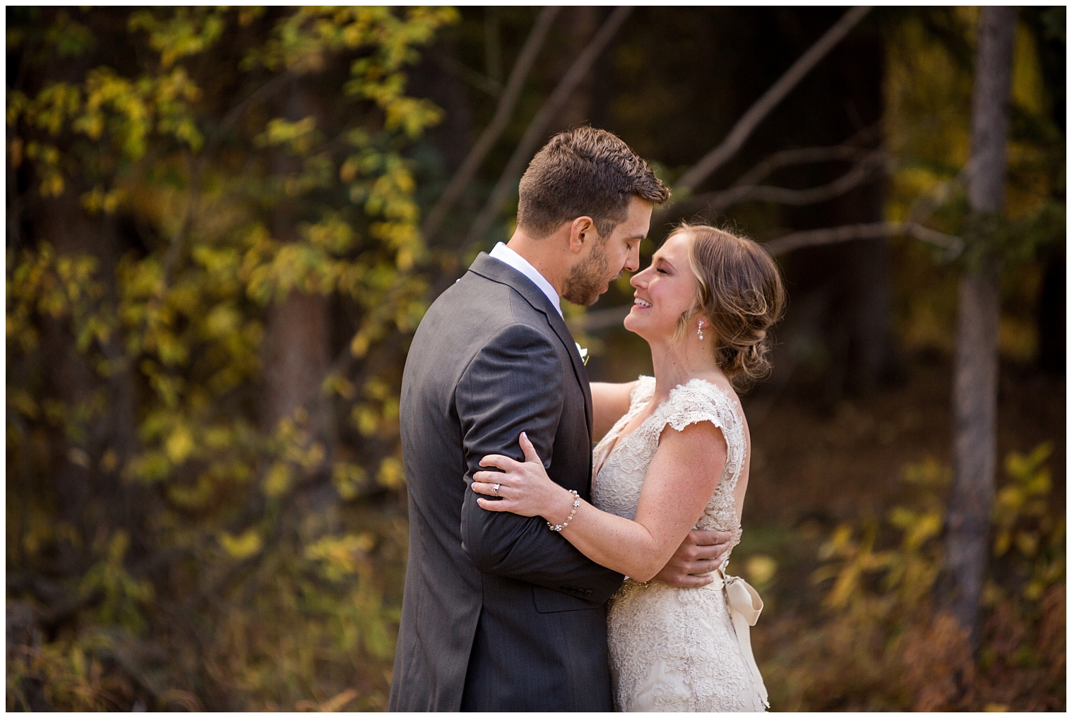 During their first look at their Copper Mountain wedding, the bride and groom hold each other and lean in for a kiss.