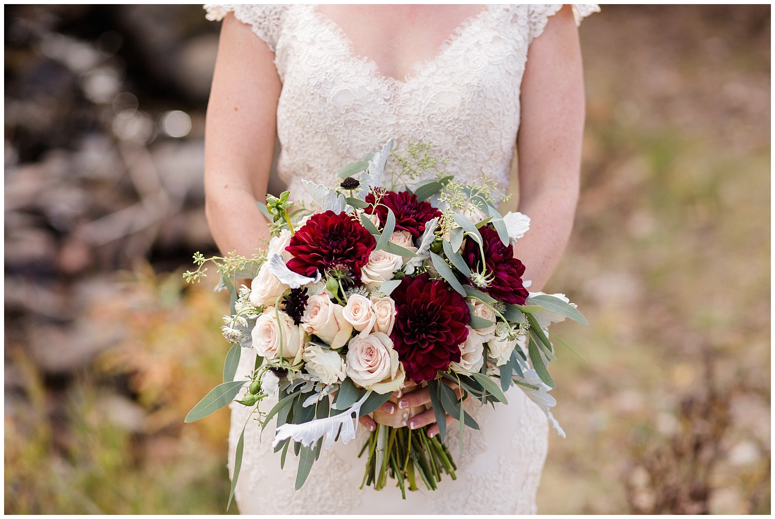 Bride holds beautiful red, pink, and white bridal bouquet during her Copper Mountain wedding day.