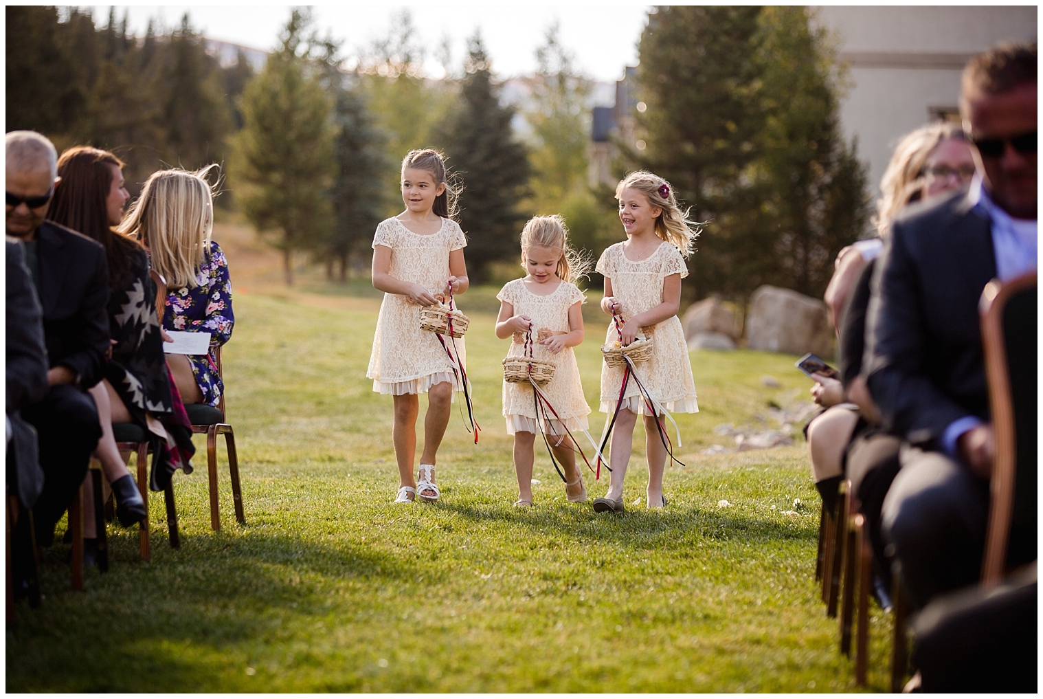 Three flower girls walk to the aisle at a Copper Mountain wedding ceremony.
