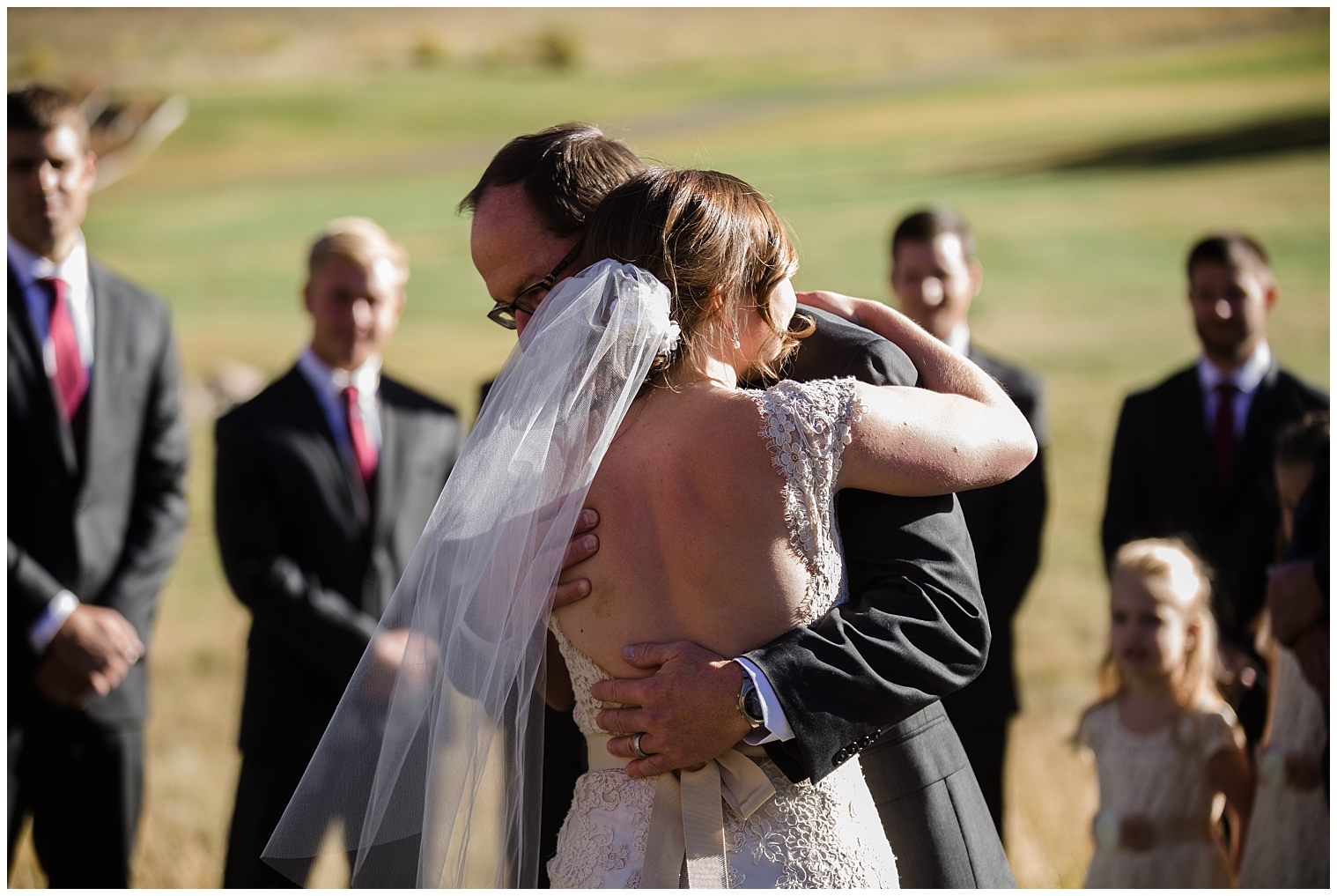 The bride hugs her father, as he walks her down the aisle at her Copper Mountain wedding ceremony.