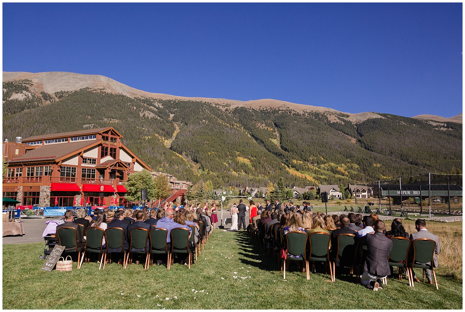 A wide shot of an outdoor wedding ceremony at the Copper Mountain wedding venue.