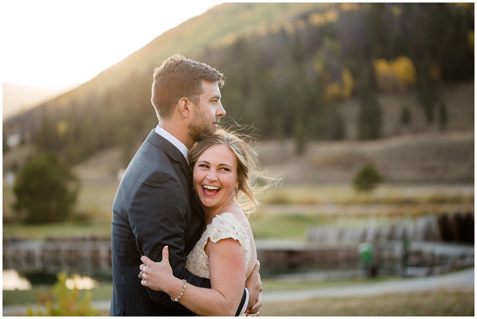 The bride laughs with joy during portraits with her groom at their Copper Mountain wedding.