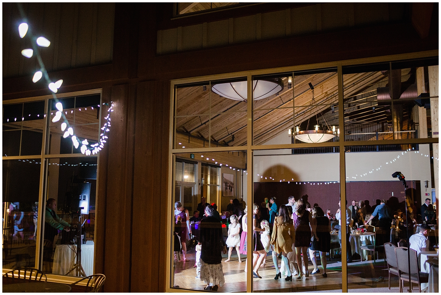 A Colorado wedding photographer captures Copper Mountain wedding reception dancing from outside the window.