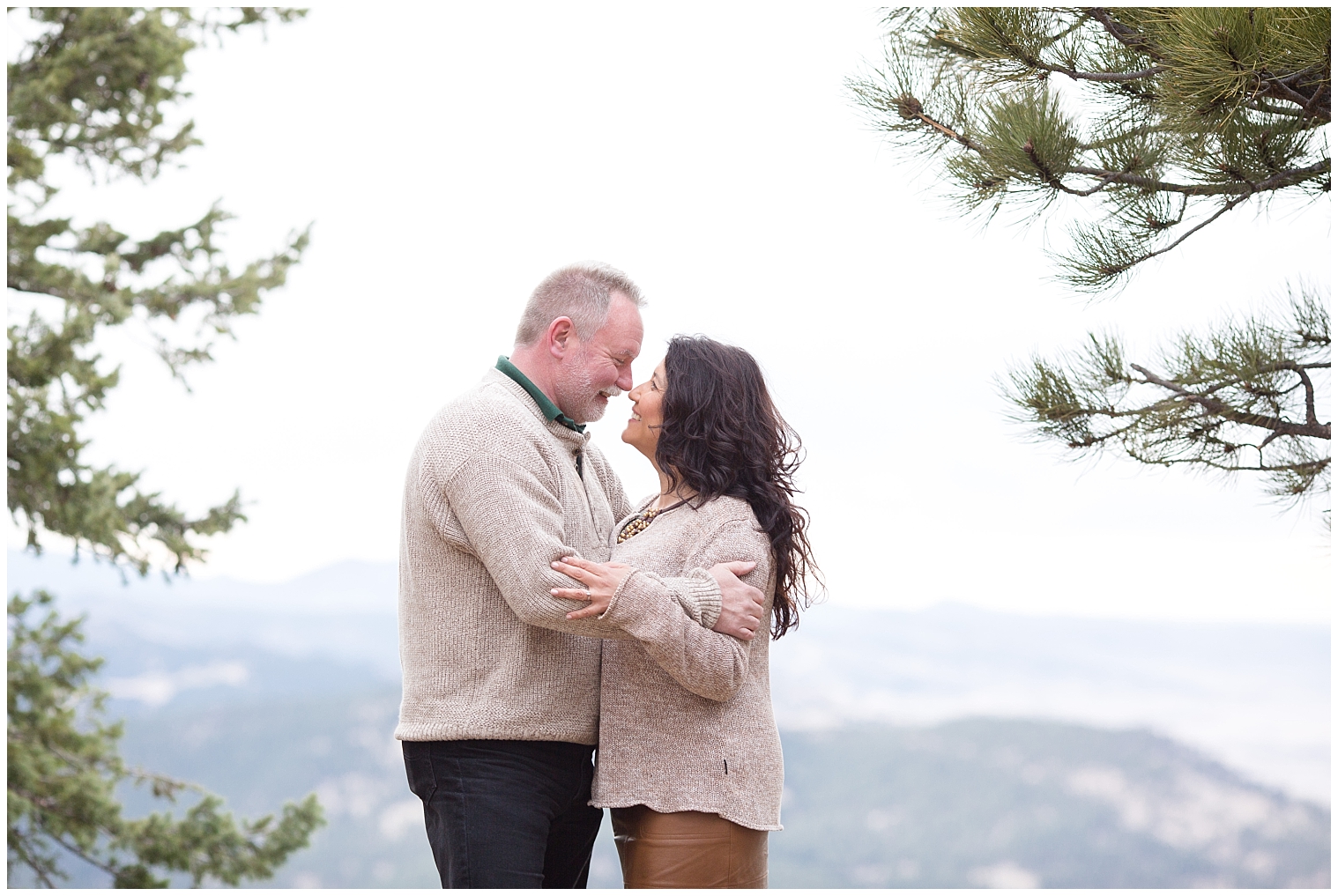 Couple stands together with mountains in the background during their Breckenridge engagement photo session
