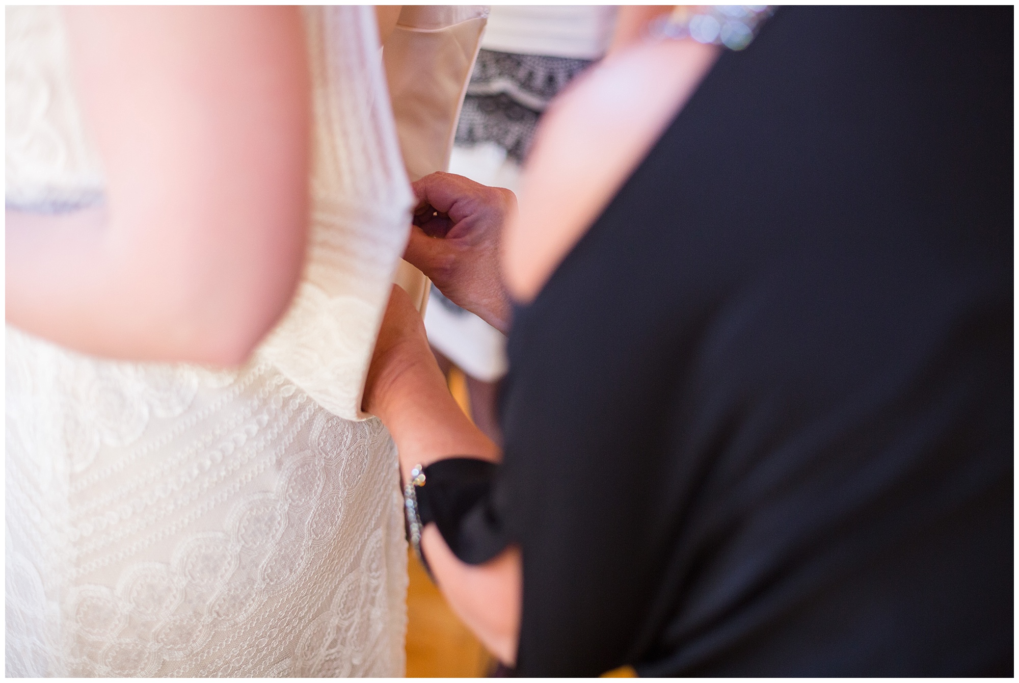 Bride is helped into her dress at her intimate Breckenridge wedding.