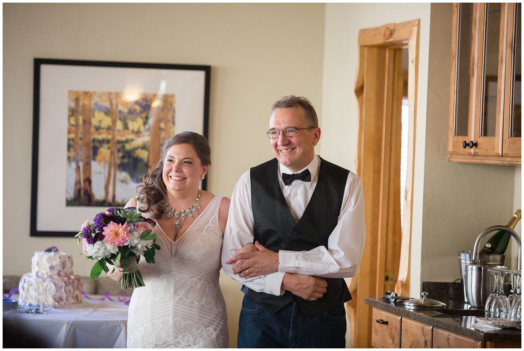 Bride is walked down the aisle by her father at a private cabin wedding in Breckenridge. 
