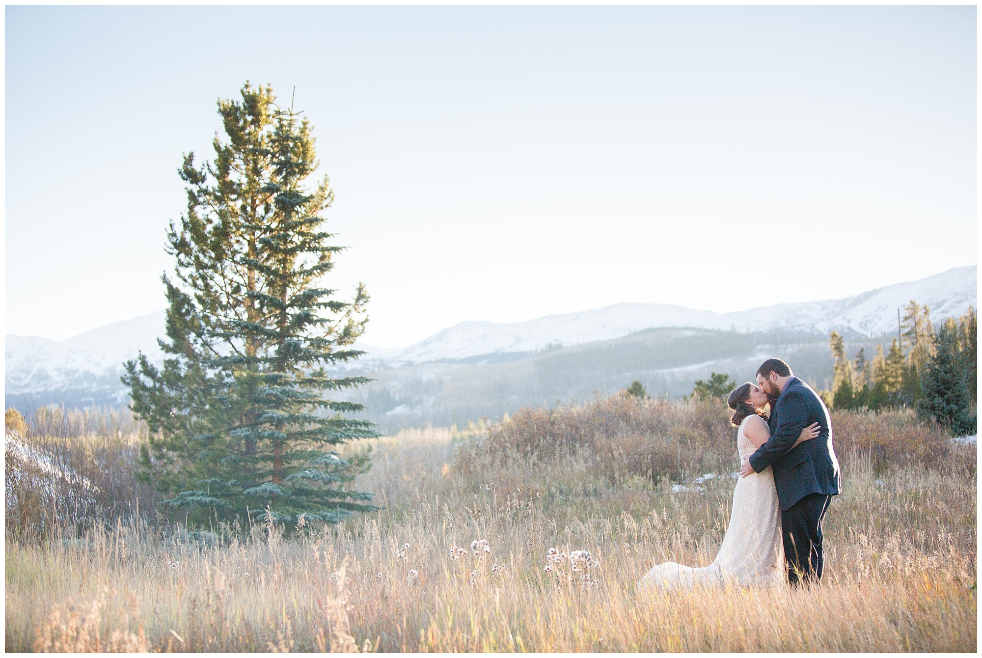 The wedding couple kiss during portraits at their Breckenridge elopement.