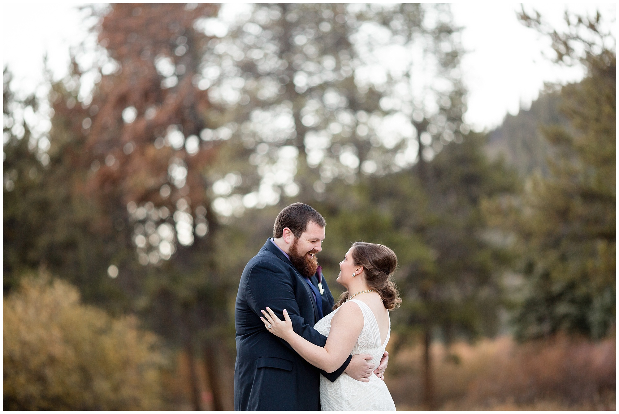Groom smiles down at his bride at their Colorado mountain elopement.