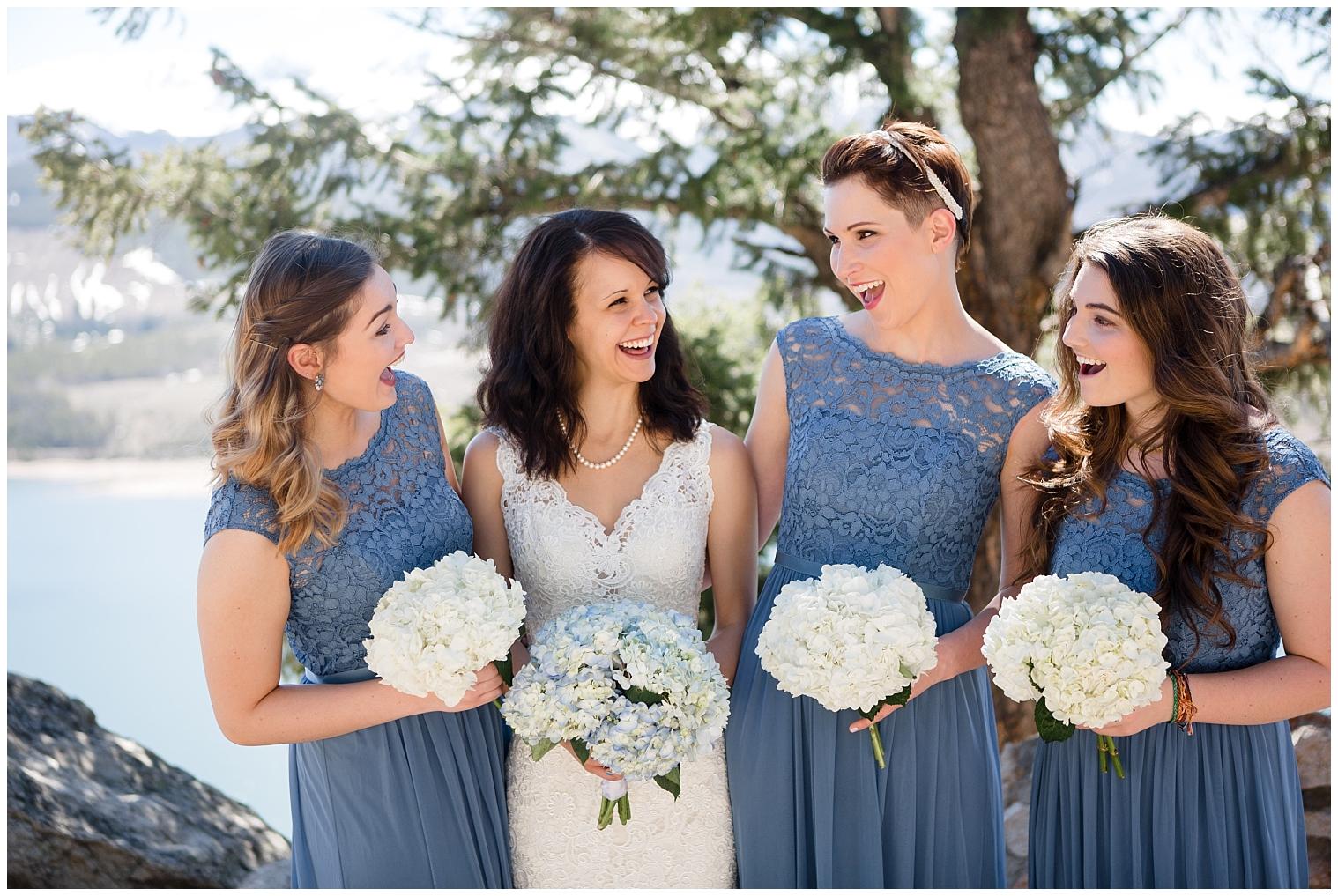 Bride poses with her bridesmaids for photos with a Breckenridge elopement photographer.