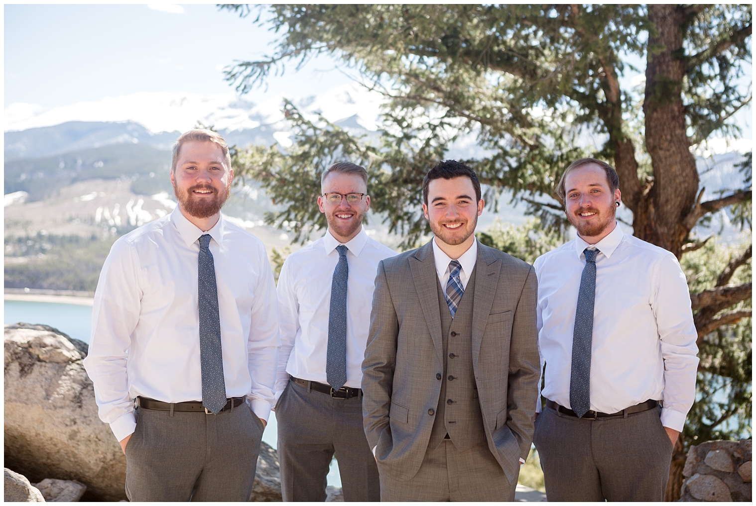 Groom poses with his groomsmen at a Colorado mountain intimate wedding.