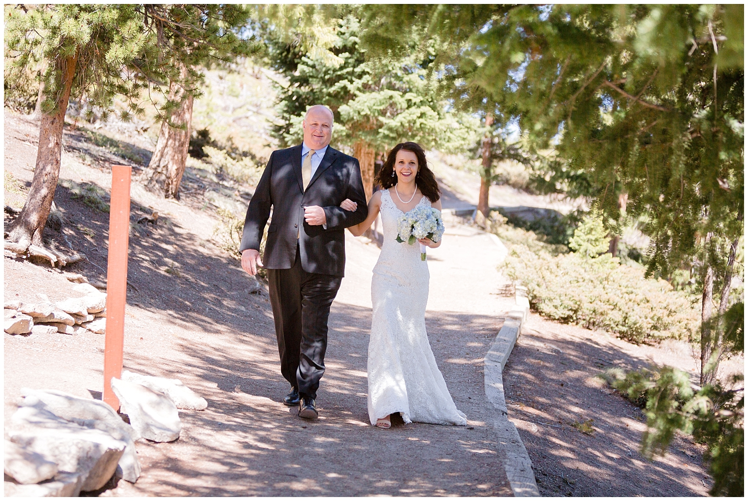 Bride is walked down the aisle at her intimate Sapphire Point Overlookc wedding.