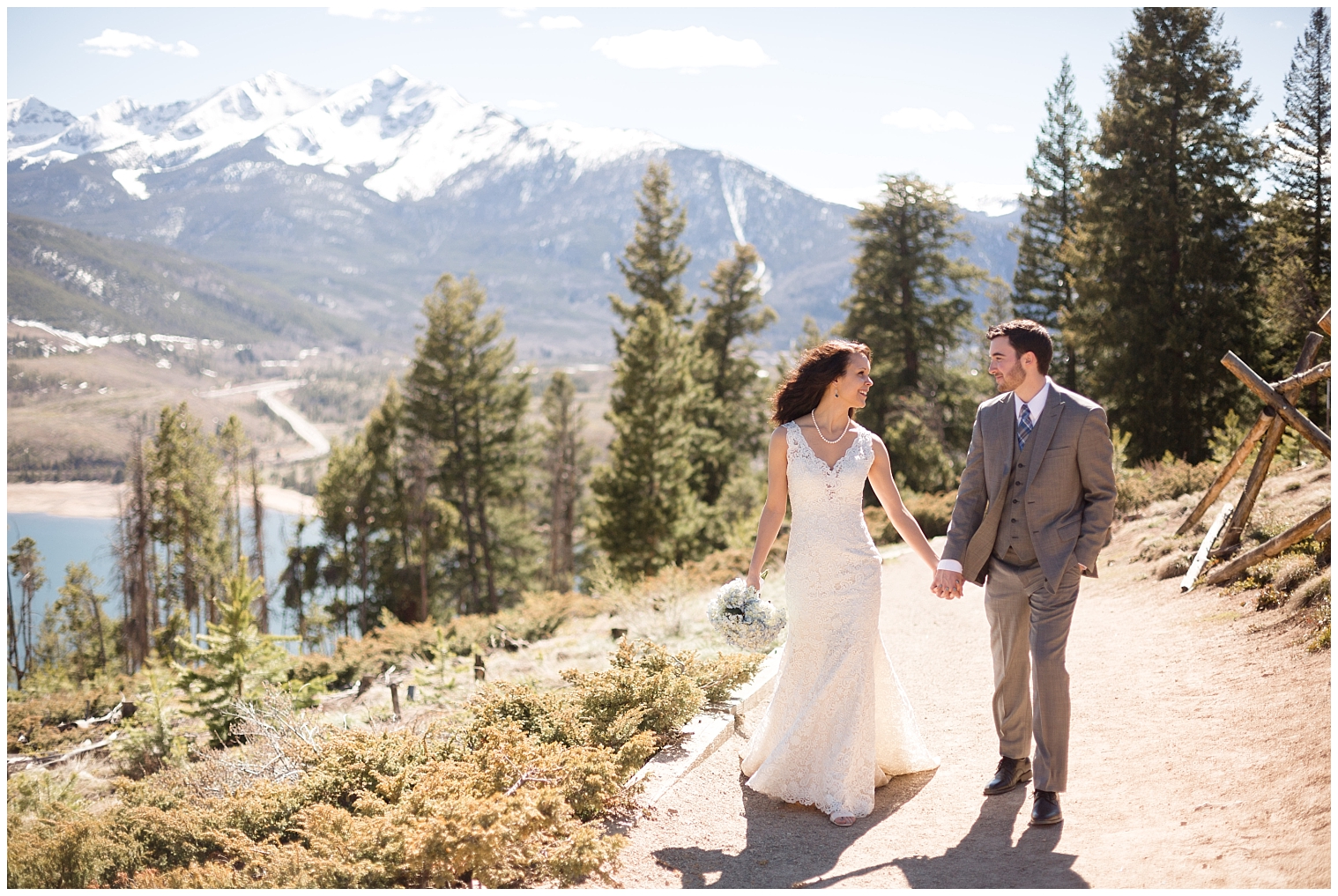 During photos with a Colorado mountain elopement photographer, the bride and groom walk hand in hand together.