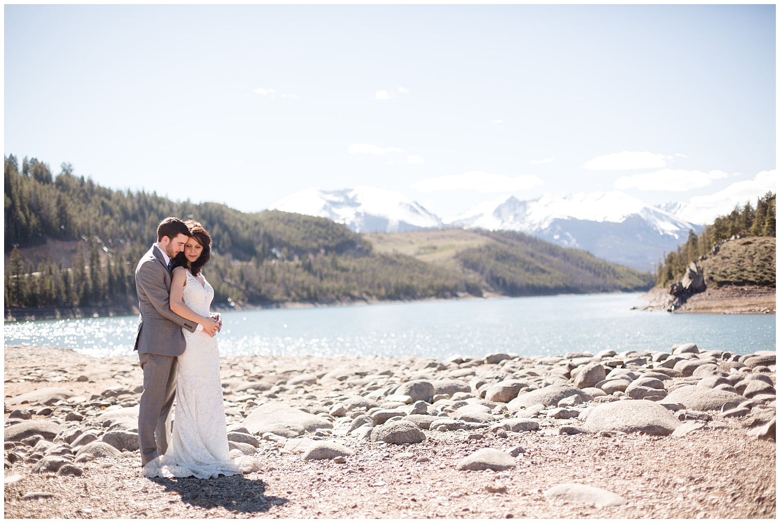 Groom holds his bride during portraits at their Breckenridge elopement.