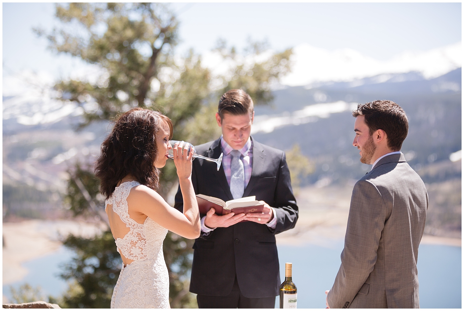 During a wine unity ceremony, the bride drinks wine at her Colorado mountain elopement.