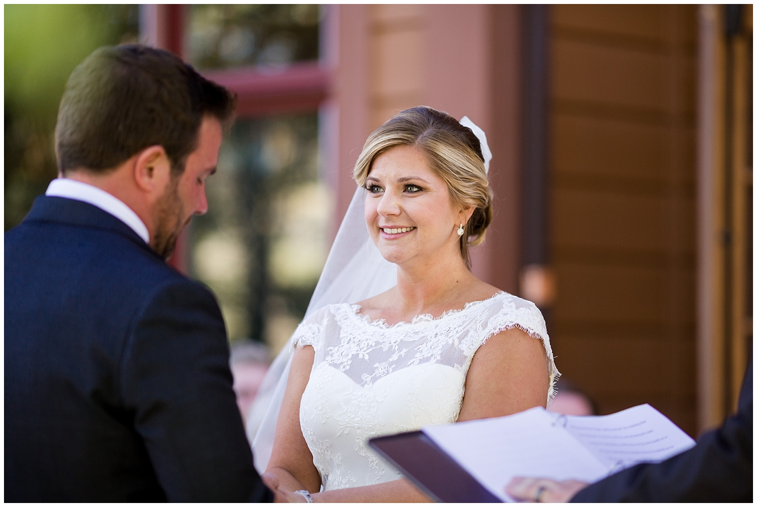 Bride looks up her at her groom during their wedding ceremony at Mountain Thunder Lodge. 