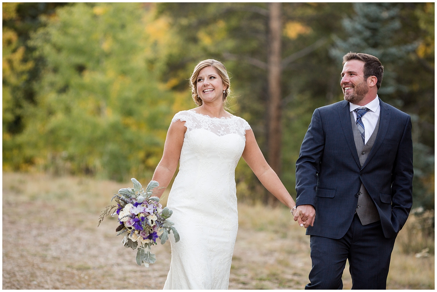 During portraits at their Breckenridge wedding, the wedding couple walk together hand in hand.