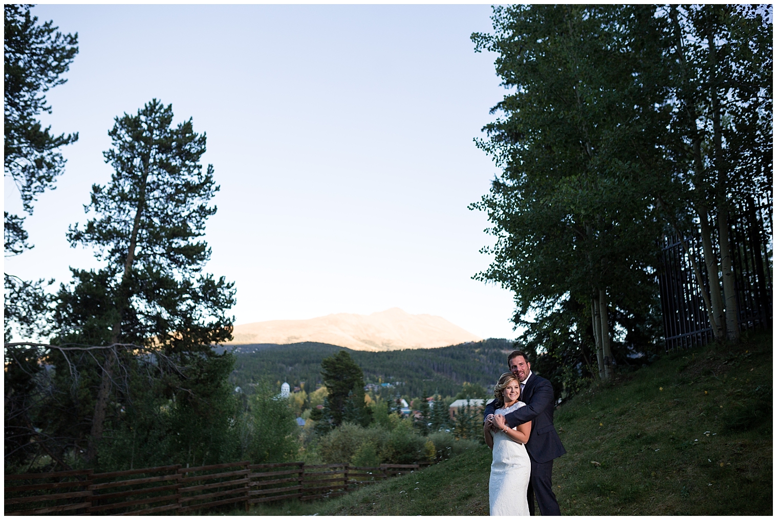 Groom holds his bride from behind during sunset portraits with a Mountain Thunder Lodge wedding photographer.