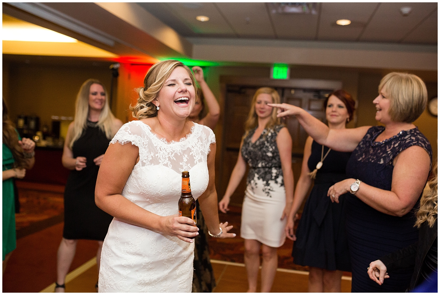 Bride laughs while dancing at her Breckenridge wedding reception.