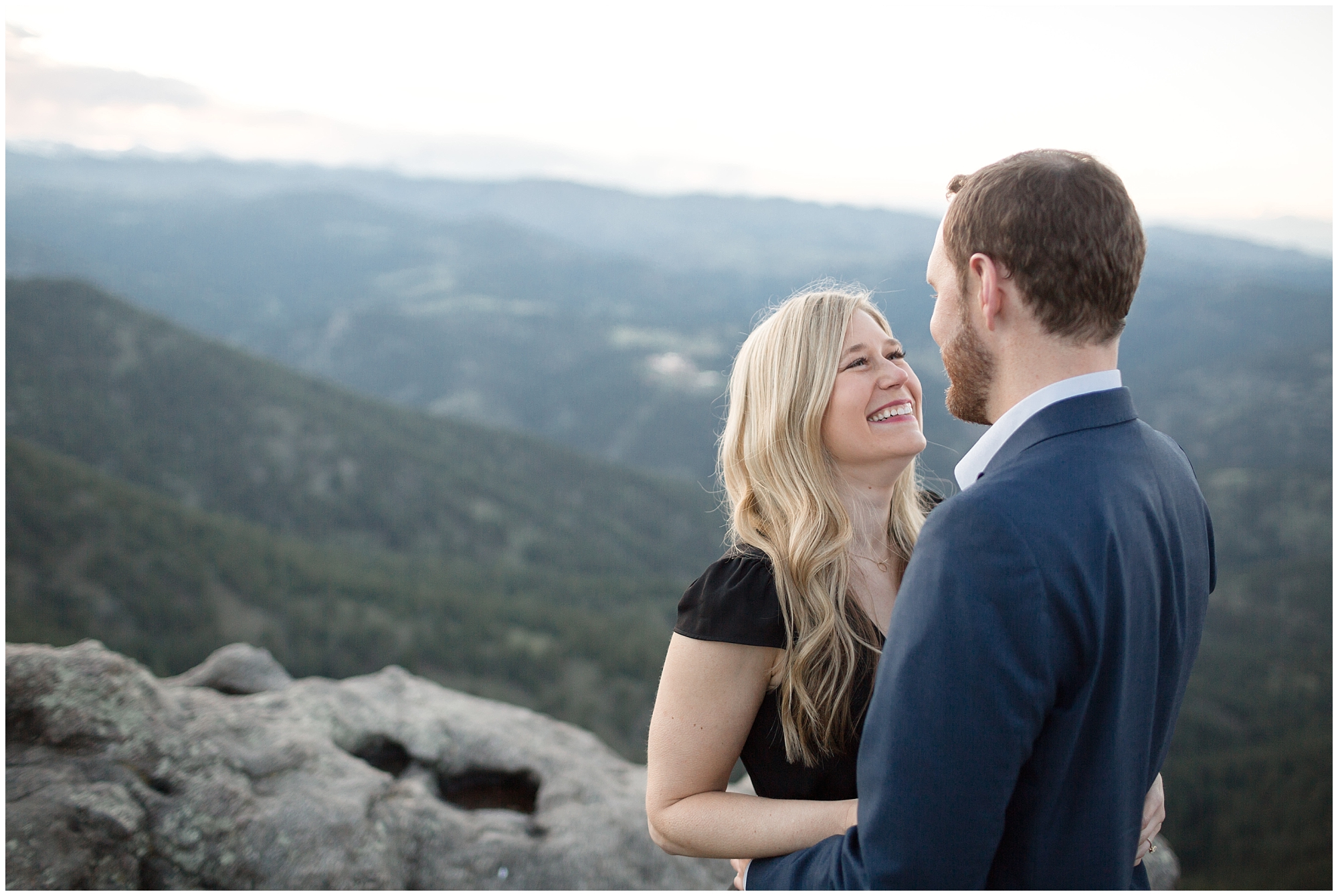Woman looks up at her fiance during their Colorado mountain engagement photos.