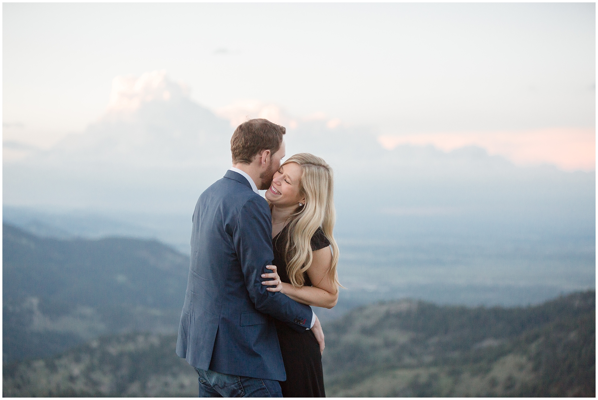 Man kisses his fiance during their session with  Colorado mountain engagement photographer.