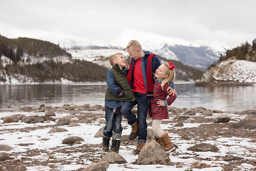 three siblings laughing at sapphire point for their family session in Breckenridge 
