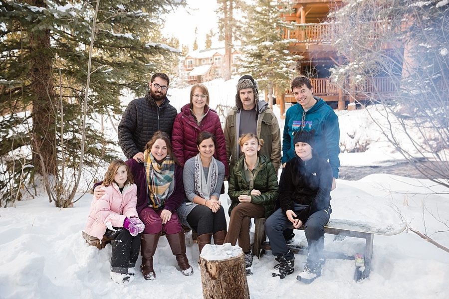 large family poses by the fire in Breckenridge