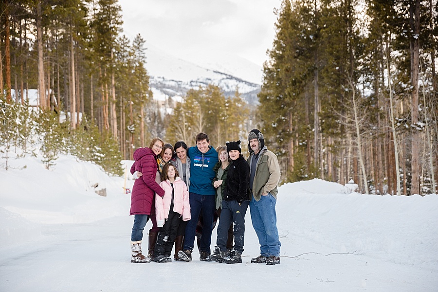large family posing in the snowy Colorado mountains in Breckenridge 