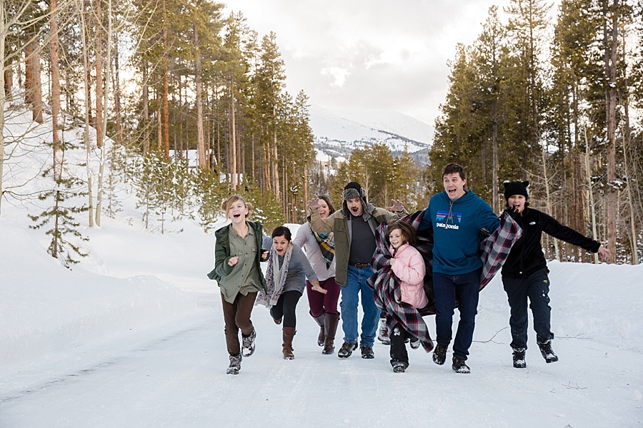 large family running and being silly in the snowy Colorado mountains in Breckenridge