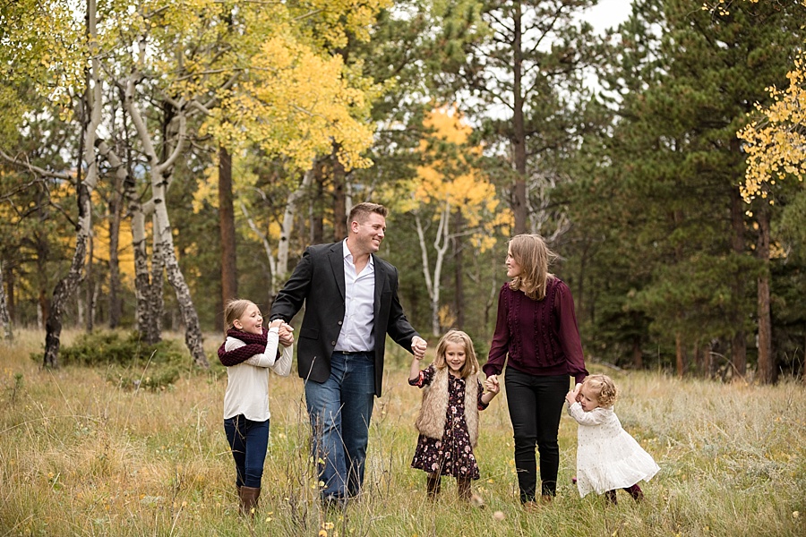Colorado mountain photographer captures family walking through meadow in the fall