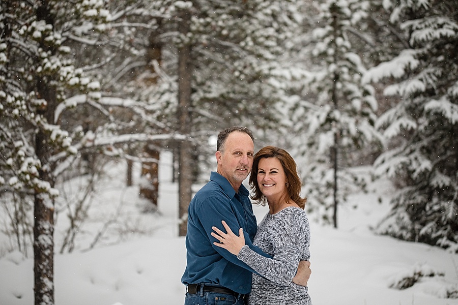 two parents hug in the snow in Breckenridge colorado