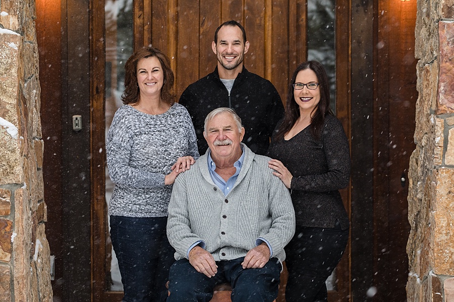 adult children pose with their father in Breckenridge Colorado 