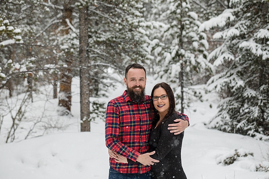 couple poses together in the snow in Breckenridge Colorado 