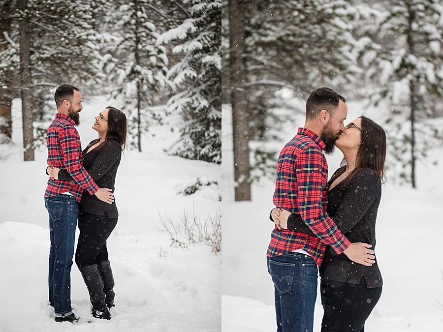 couple wearing plaid kiss in the snow in Breckenridge Colorado